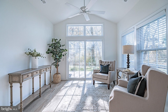 sitting room featuring ceiling fan, vaulted ceiling, and light wood-type flooring