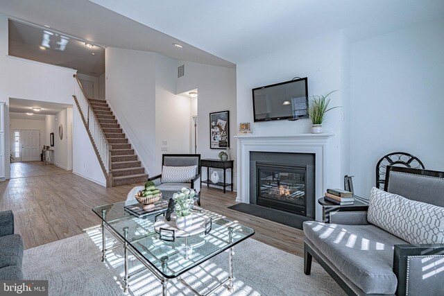 living room featuring light wood-type flooring and vaulted ceiling