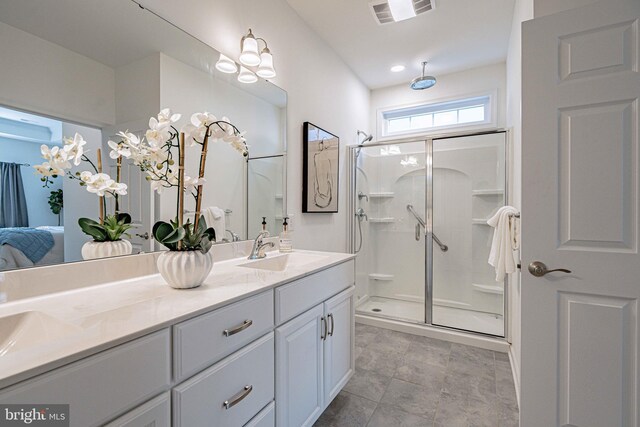 bathroom with vanity and a shower with shower door