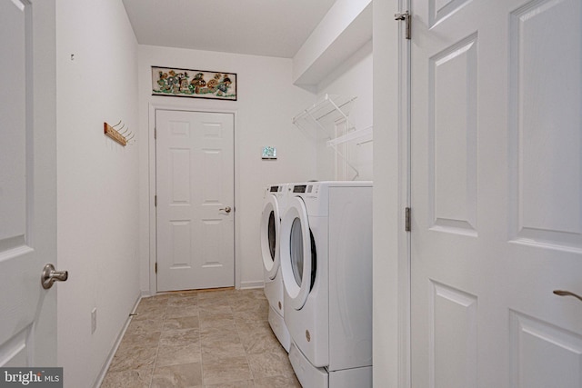 clothes washing area with washing machine and dryer