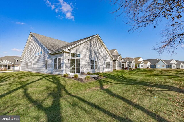 rear view of property featuring a yard