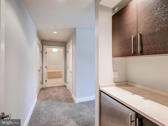 hallway featuring light carpet