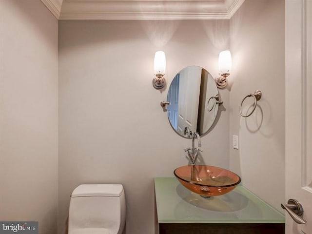 bathroom featuring vanity, toilet, and ornamental molding