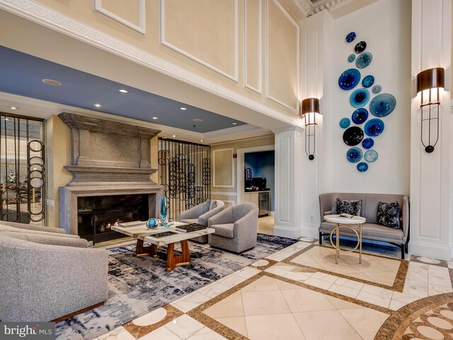 801 Key Hwy Unit 323, Baltimore, MD 21230 - living area with inlaid floor details, a fireplace, recessed lighting, a decorative wall, and crown molding
