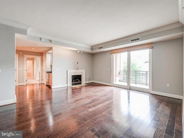 unfurnished living room featuring dark hardwood / wood-style floors and crown molding