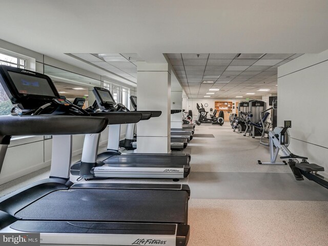 workout area featuring a drop ceiling