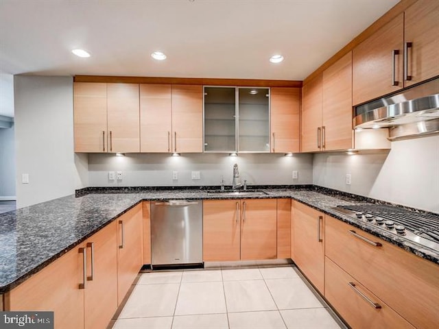 801 Key Hwy Unit 323, Baltimore, MD 21230 - kitchen featuring a sink, stainless steel appliances, dark stone countertops, light tile patterned floors, and under cabinet range hood
