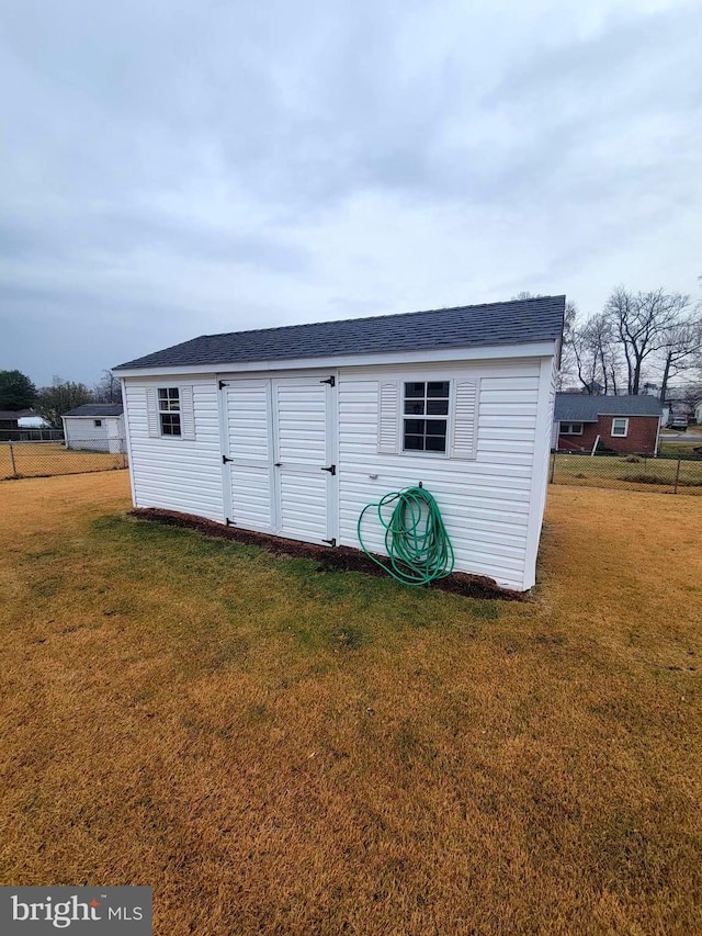 view of outbuilding with a yard