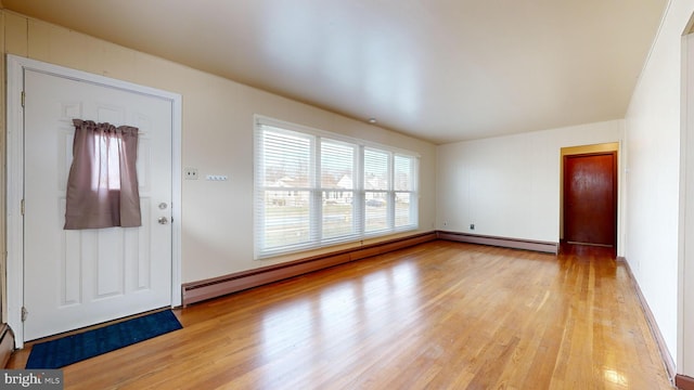 entrance foyer featuring baseboard heating and light hardwood / wood-style flooring