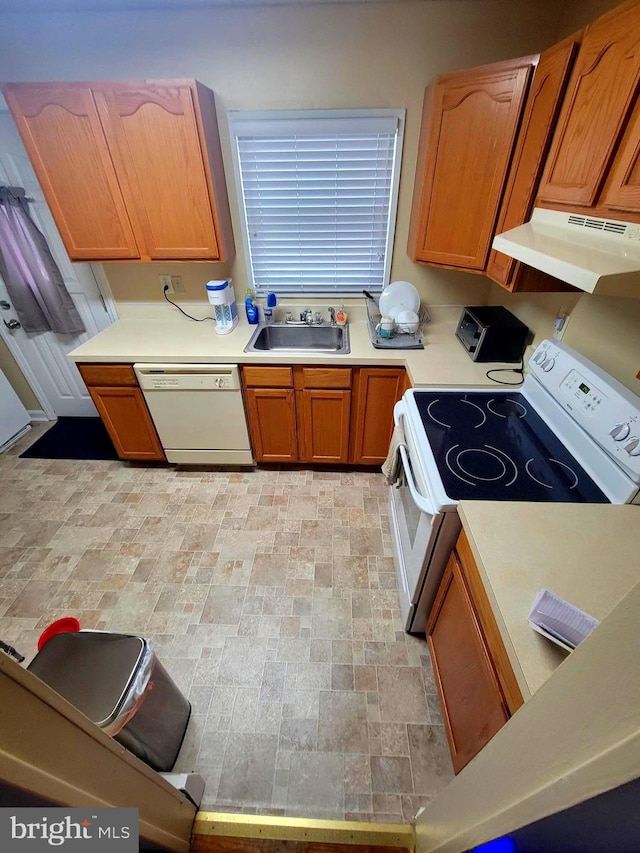 kitchen featuring white appliances, sink, and extractor fan