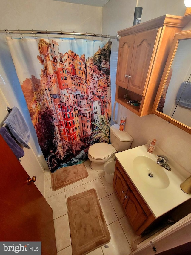 bathroom featuring tile patterned flooring, a shower with curtain, vanity, and toilet