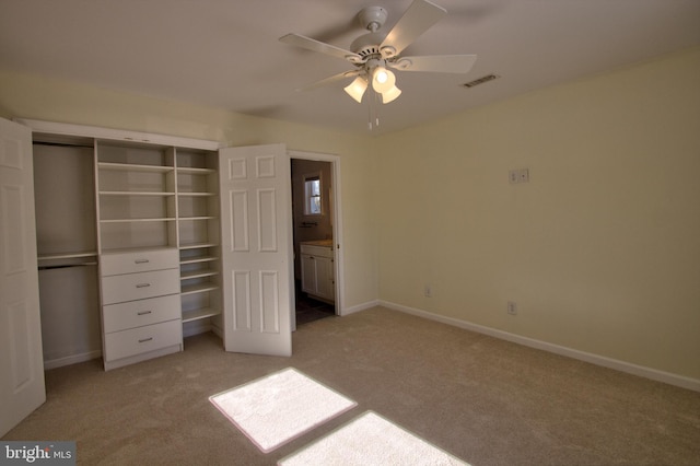 unfurnished bedroom featuring ceiling fan, a closet, and light colored carpet