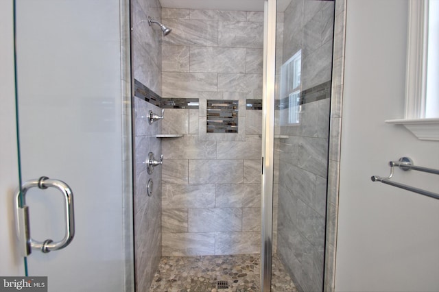 bathroom with a shower with door