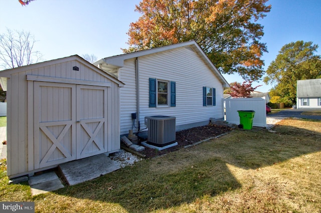 exterior space featuring a yard and central air condition unit