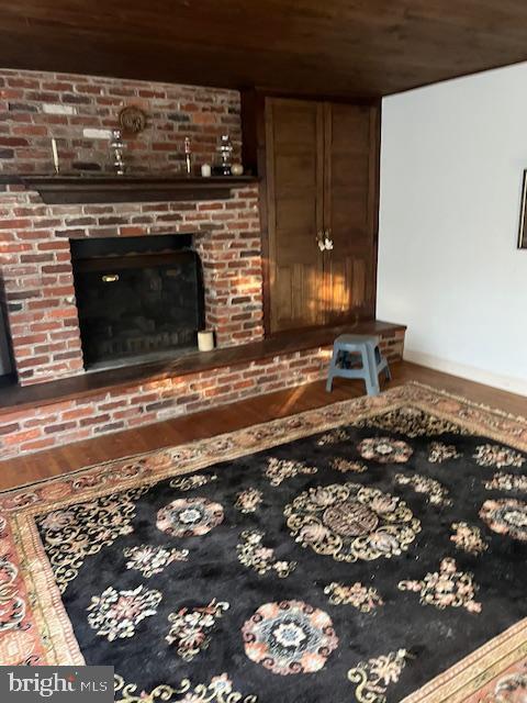 room details with a fireplace and wood ceiling