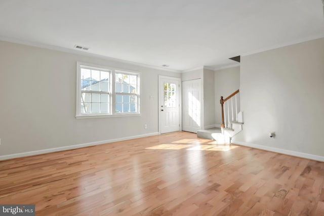 entryway featuring light hardwood / wood-style floors and crown molding