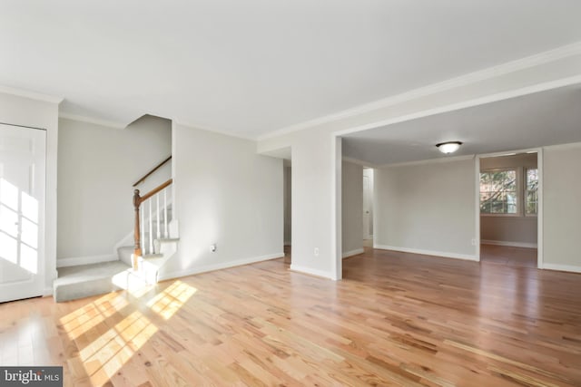 unfurnished living room featuring light wood-type flooring and crown molding