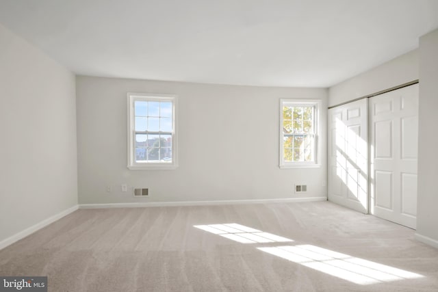 unfurnished bedroom with light colored carpet