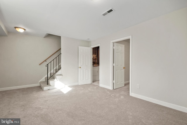 carpeted empty room featuring washer / clothes dryer