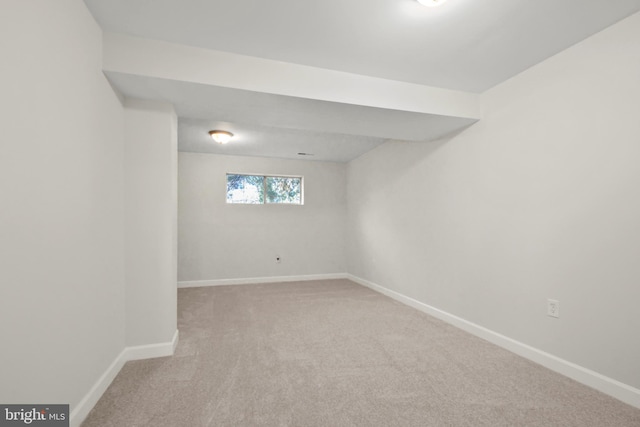 basement featuring light carpet