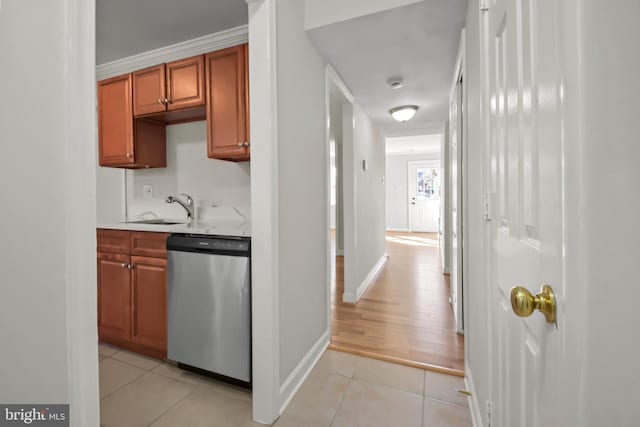 kitchen featuring stainless steel dishwasher, light hardwood / wood-style floors, crown molding, and sink