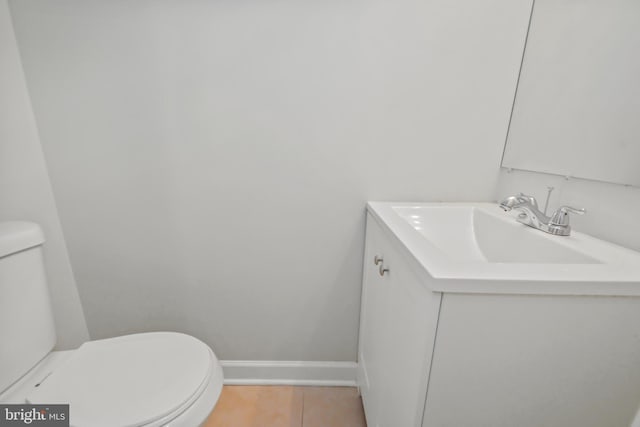 bathroom with tile patterned floors, vanity, and toilet