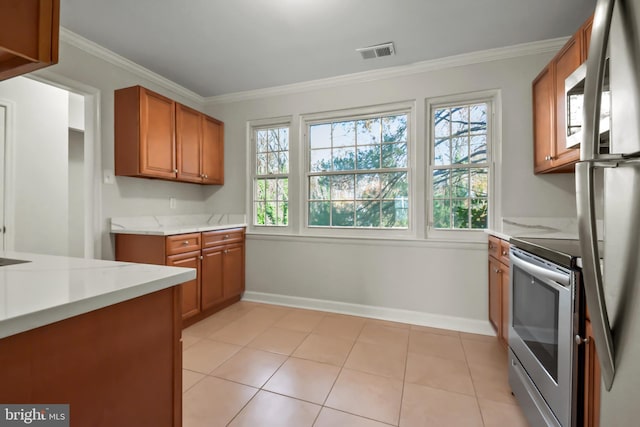 kitchen featuring crown molding, light tile patterned floors, light stone counters, and stainless steel range oven