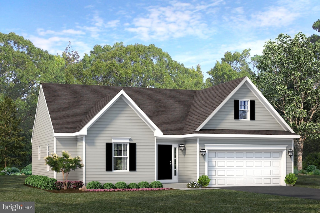 view of front of house with a garage and a front lawn