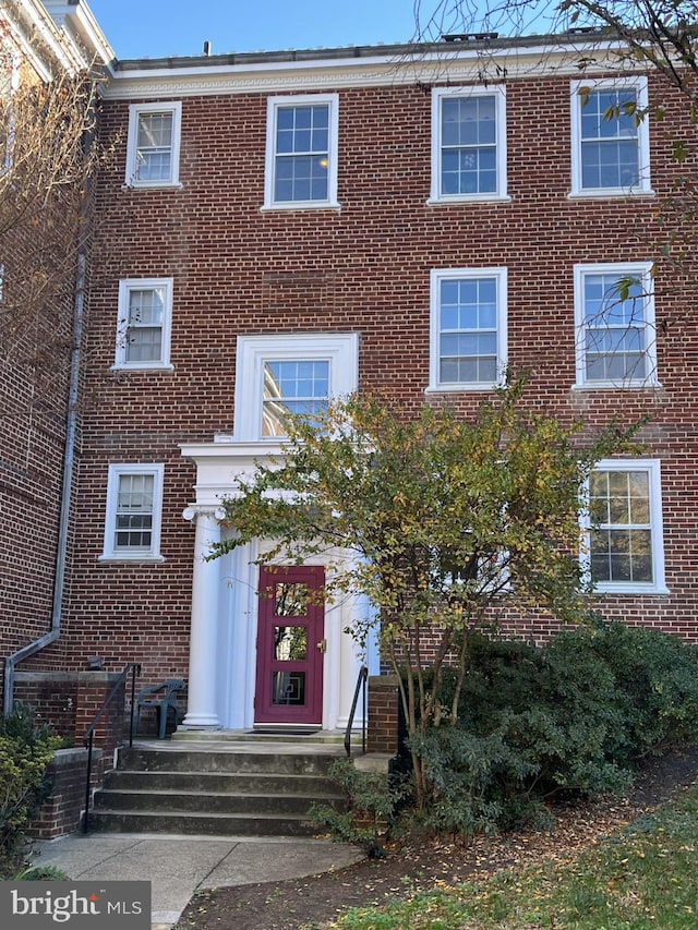 view of property featuring brick siding