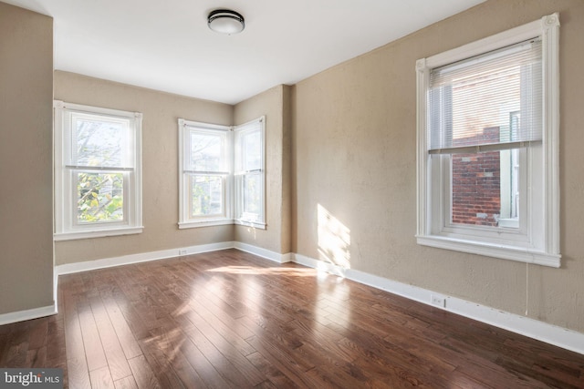 spare room with dark hardwood / wood-style flooring