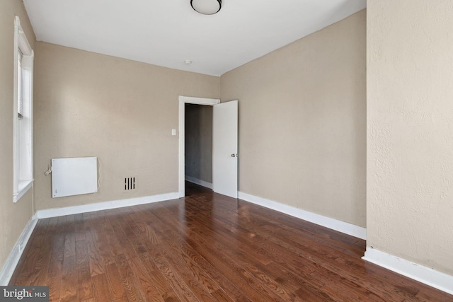 unfurnished room featuring dark hardwood / wood-style floors