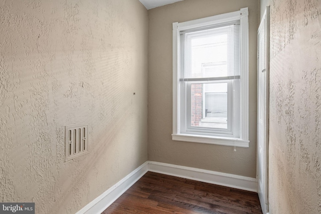 spare room featuring dark hardwood / wood-style floors