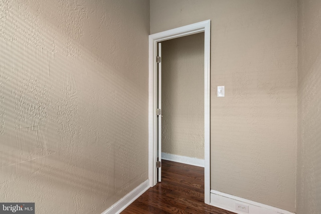 corridor with dark wood-type flooring