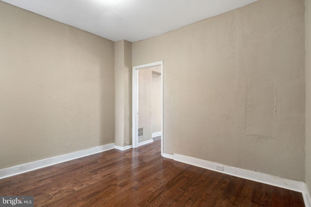 unfurnished room featuring dark hardwood / wood-style flooring