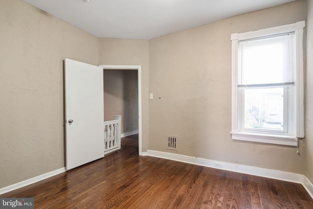 empty room featuring dark hardwood / wood-style floors