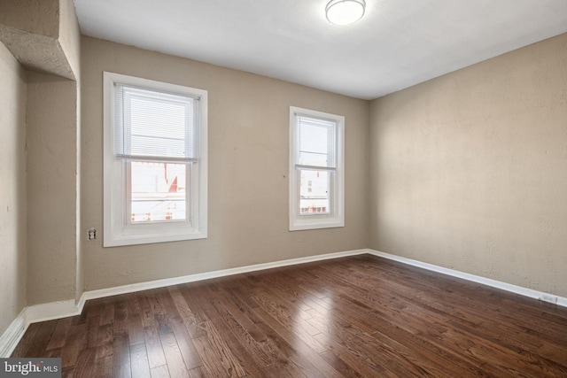 empty room with dark wood-type flooring