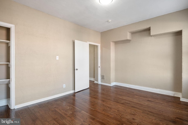 unfurnished bedroom featuring dark hardwood / wood-style floors