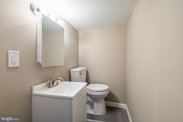 bathroom featuring hardwood / wood-style floors, vanity, and toilet