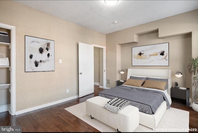 bedroom with dark wood-type flooring