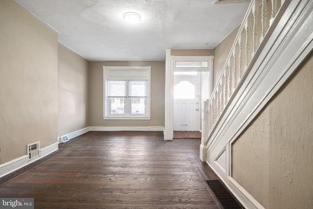 foyer entrance with dark hardwood / wood-style floors