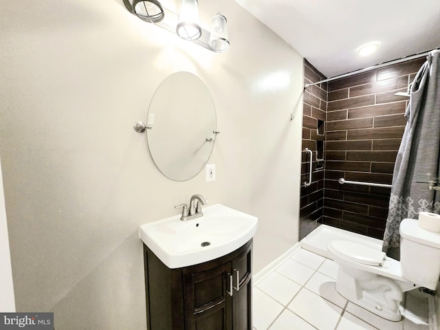 bathroom with tiled shower, tile patterned floors, vanity, and toilet