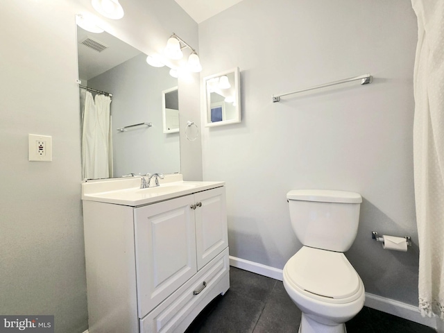 bathroom with tile patterned floors, vanity, and toilet