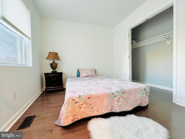 bedroom featuring a closet and dark hardwood / wood-style floors