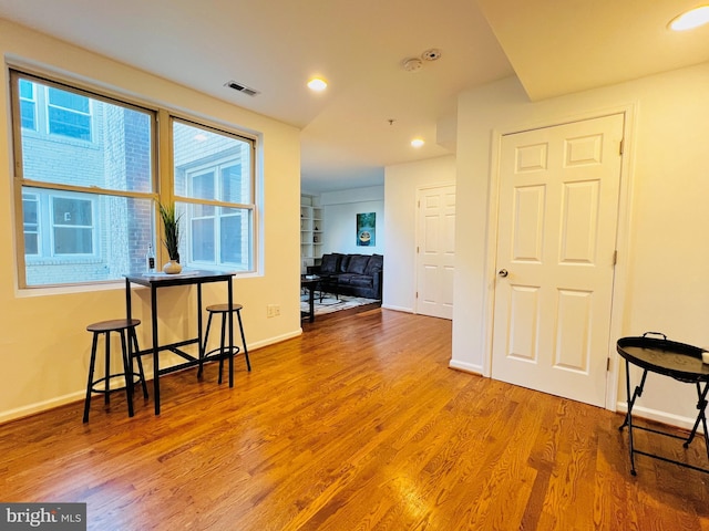 unfurnished room with hardwood / wood-style flooring