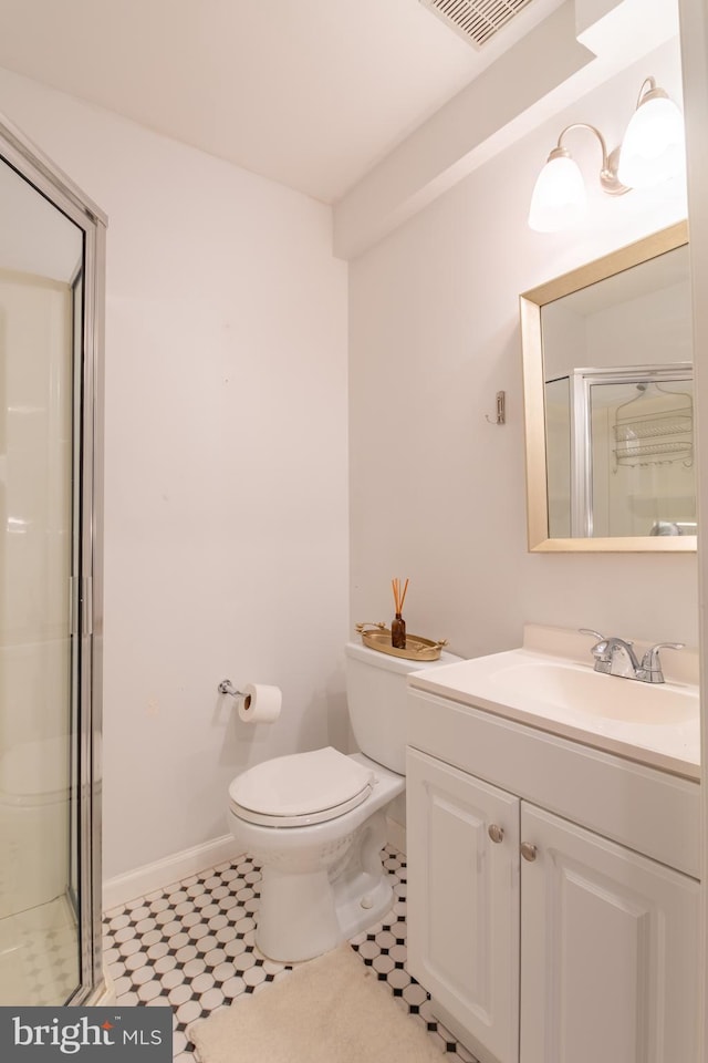 bathroom with vanity, toilet, and walk in shower