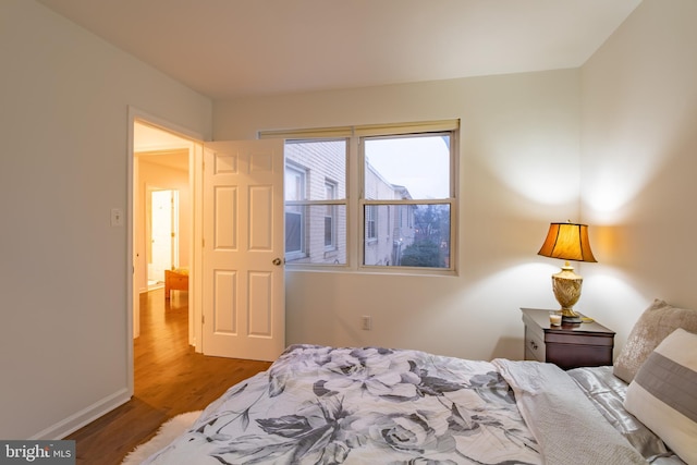 bedroom with wood-type flooring