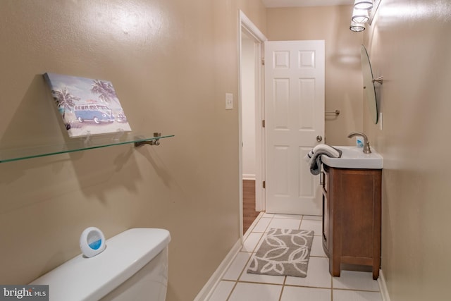 bathroom featuring toilet, vanity, and tile patterned floors