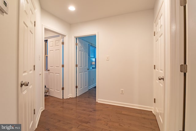 corridor with dark hardwood / wood-style flooring