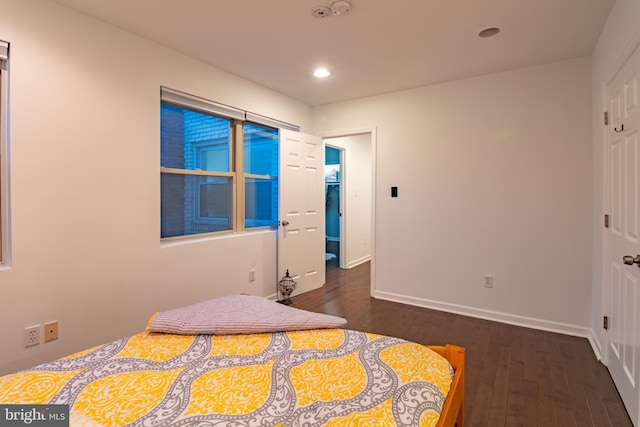 bedroom with dark wood-type flooring