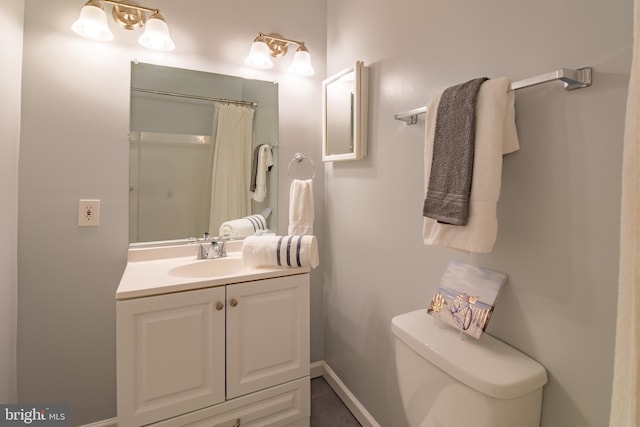 bathroom featuring tile patterned floors, a shower with curtain, vanity, and toilet